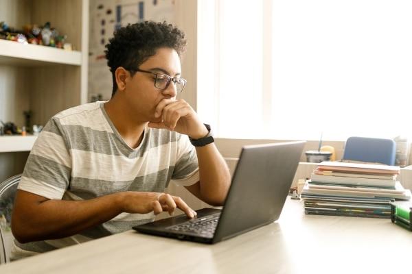 student studying on laptop at home